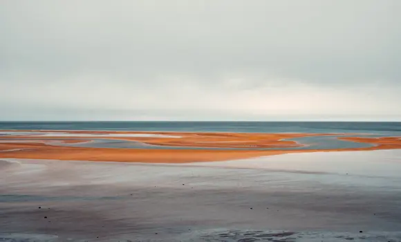 Red sands along the shoreline of Rauðisandur Beach in the Westfjords of Iceland.