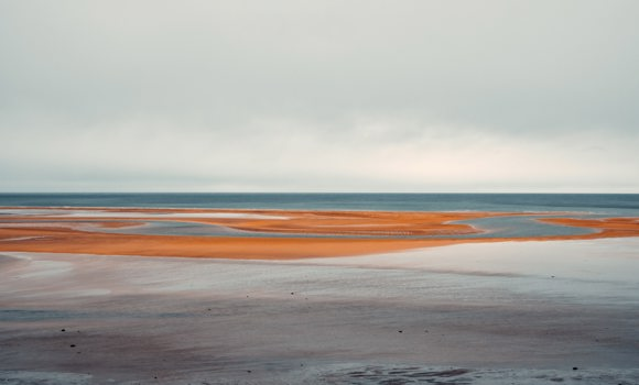 Red sands along the shoreline of Rauðisandur Beach in the Westfjords of Iceland.