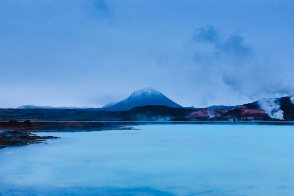 Mývatn Nature Baths with a tall mountain in the background.