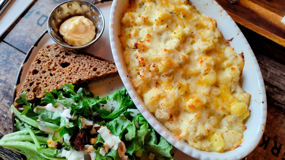 Traditional Icelandic fish stew in a dish alongside salad and rye bread