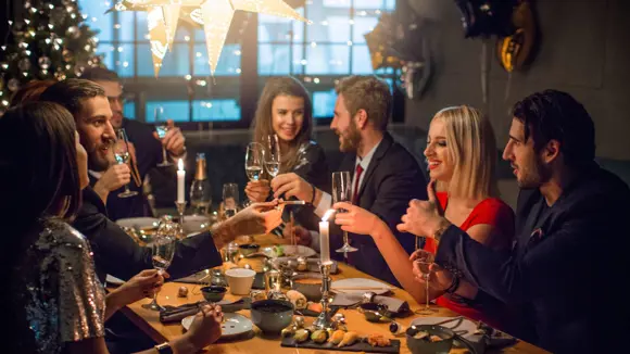 People raising a toast during a New Year’s Eve party.