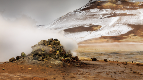 Small hill of rocks emitting steam on Námaskarð Pass.