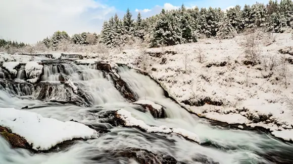 Waterfall at Elliðaárdalur Valley in the snow.