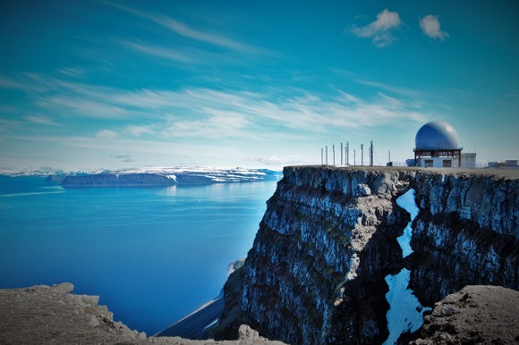 A view from Bolafjall on a clear day across the fjords including the radar station.