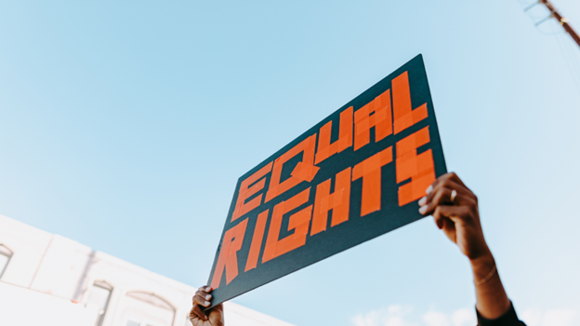  A person holding a poster that read equal rights.