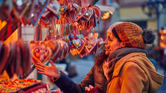 Two women looking at Christmas market decorations