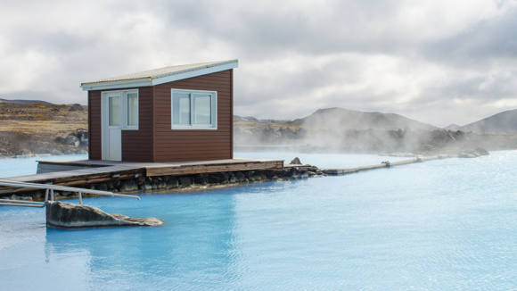 Outbuilding standing above the blue waters of Myvatn nature baths.