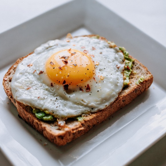 Egg on avocado toast in a breakfast restaurant.