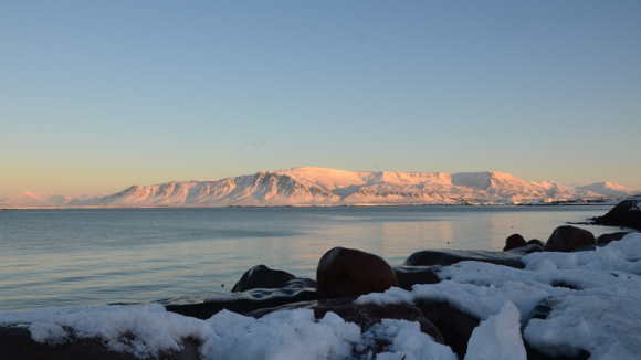 Reykjavík seafront in the winter with chunks of ice in the foreground.