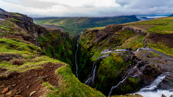 Views from the top of Glymur over mossy mountains.